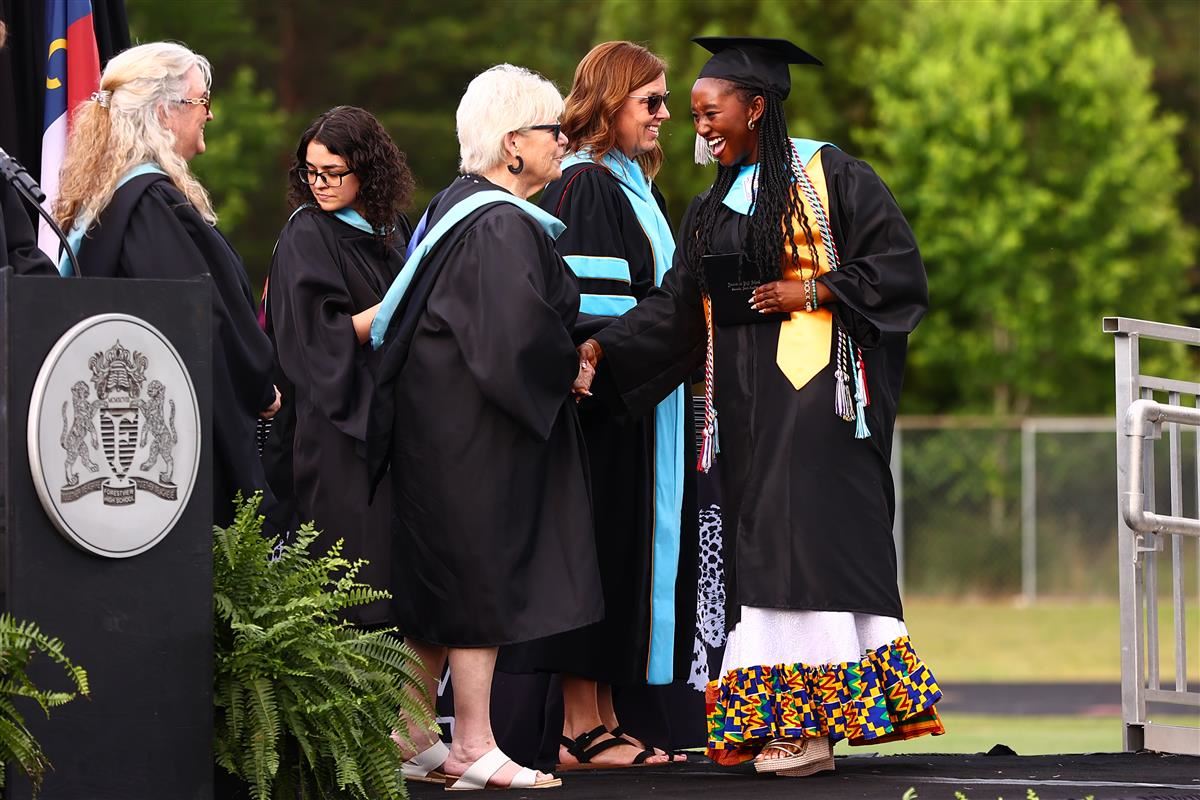 Photo of Naami Abbey receiving her diploma at graduation.